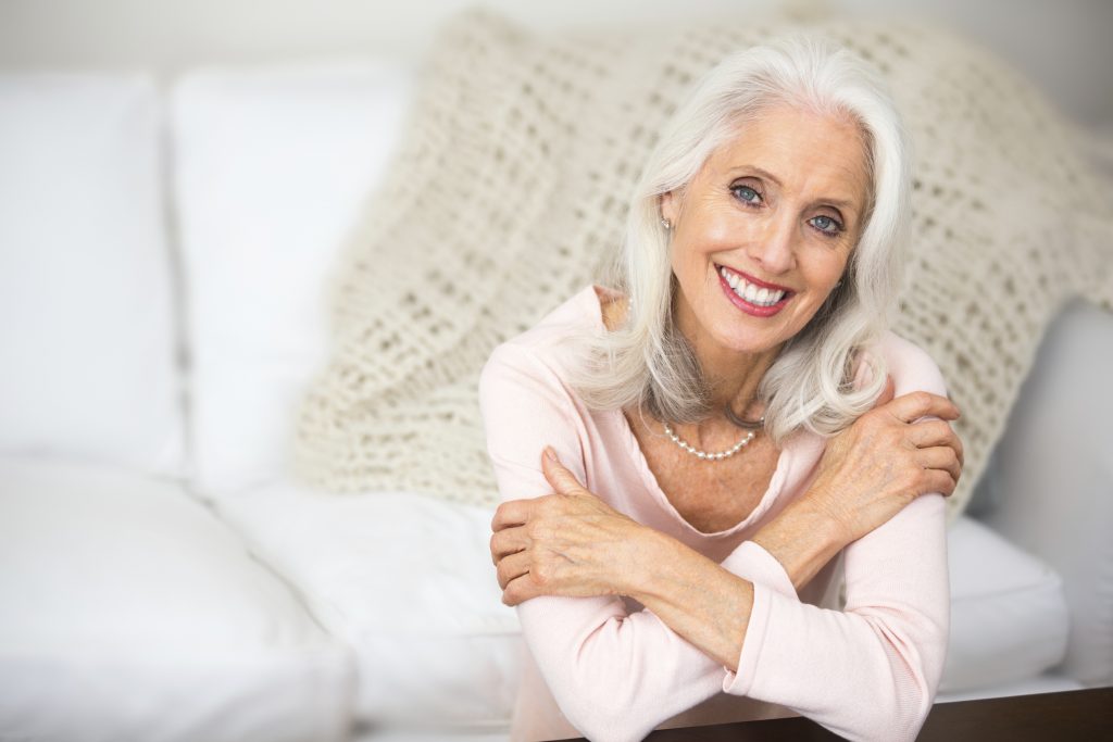 Portrait of a beautiful senior woman with dentures.