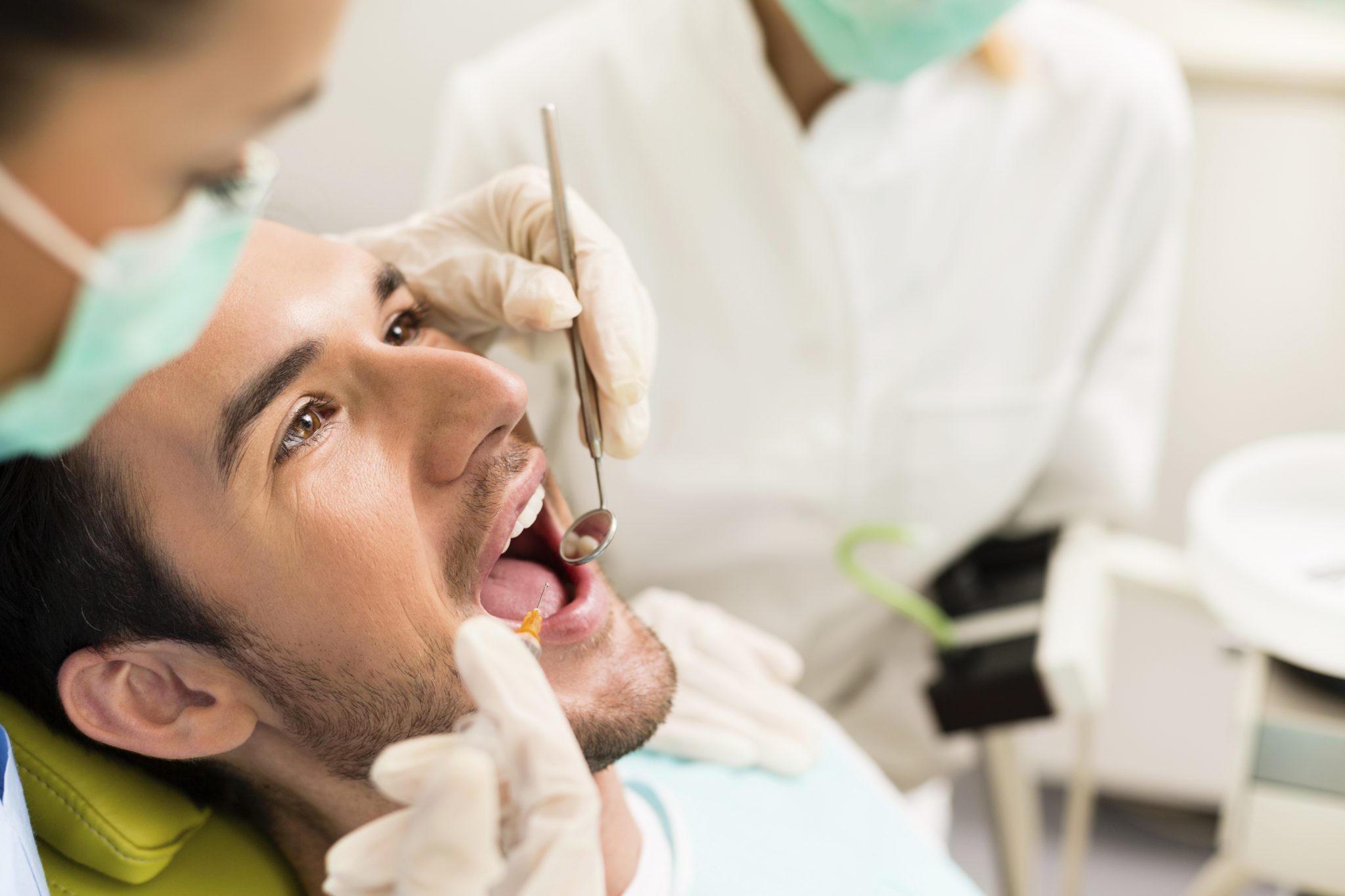 Male patient at the dentist getting a root canal.